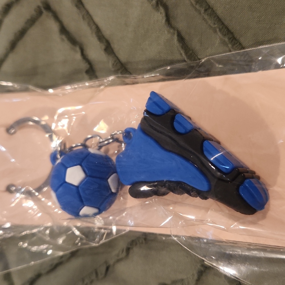 Blue & black sneaker & soccer keychain.